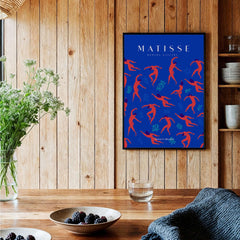 Matisse Art Prints -  Dancing Figures Pattern Red Blue Poster displayed on a wooden wall with flowers and dishes.