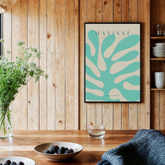 Matisse Art Prints - Mint Green Coral Abstract Seaweed Poster displayed in a cozy interior with wooden elements.