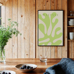 Matisse Art Prints - Lime Green Abstract Coral Shape Poster displayed on wooden wall with plants and decor.