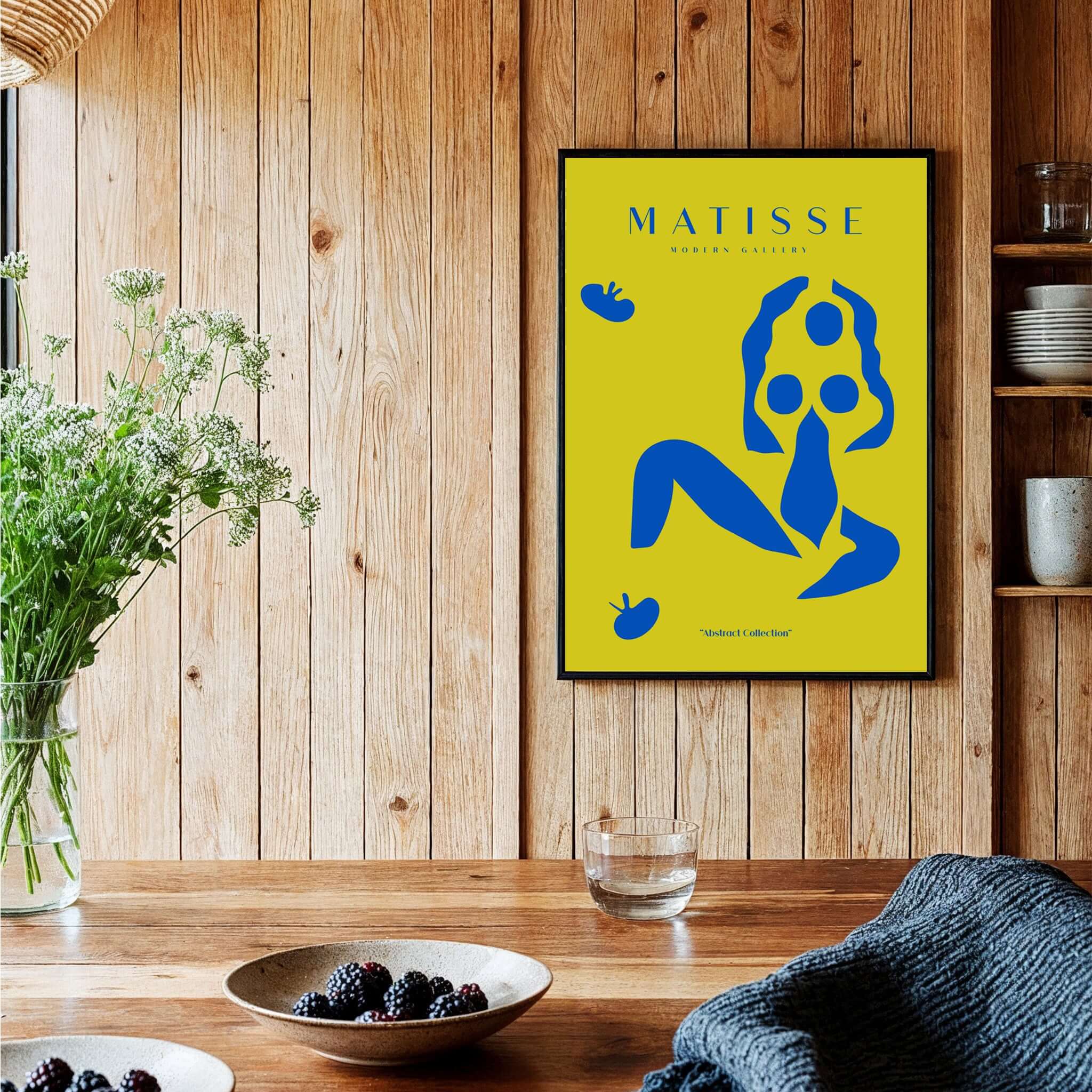 Matisse Art Prints - Blue Nude Abstract Figure Yellow Poster on a wooden wall with plants and table decor.