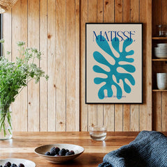 Matisse Cyan Blue Abstract Shape Papiers Découpés Poster displayed in a wooden interior with decorative elements.