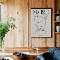 Matisse Art Print La Pompadour 1951 Minimalist Line Drawing Poster displayed in a cozy interior with plants and tableware.
