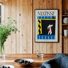 Matisse Art Print - The Clown 1943 Jazz Series Abstract Figure Poster displayed in a wooden interior with plants.