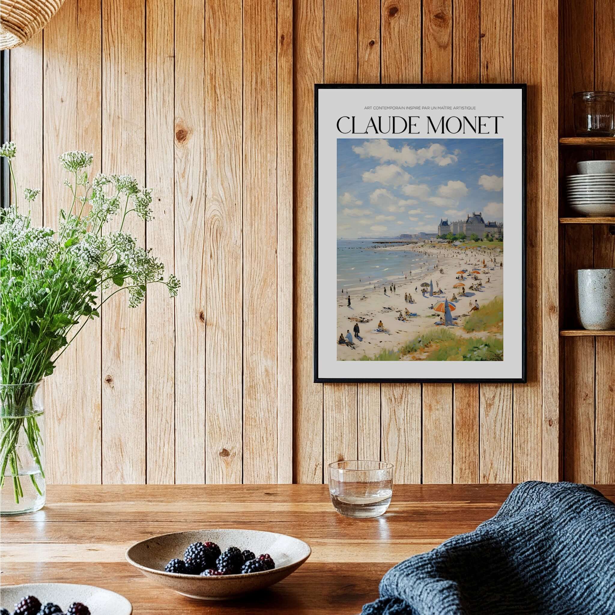 Claude Monet Sunny Beach Day Wall Art - Coastal Resort Scene Print displayed on a wooden wall with greenery and decor.