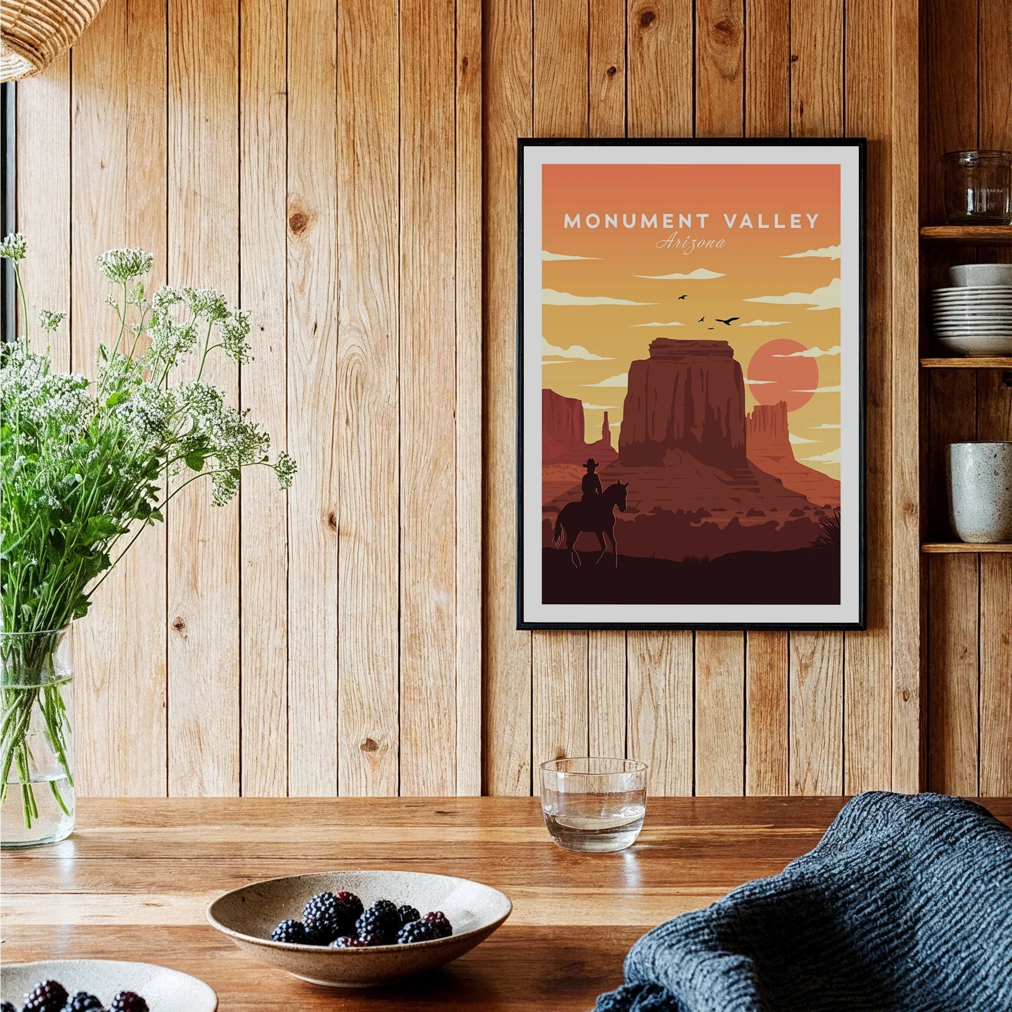Monument Valley Arizona art print in black frame hanging in rustic wood kitchen decor setting