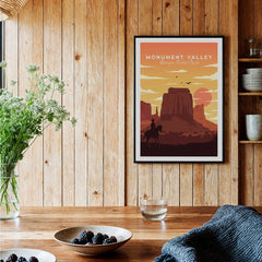 Framed Monument Valley art print in rustic kitchen setting with wood walls and natural light.