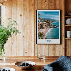 Nerja Spain Poster | Mediterranean Beach Landscape Canvas Print displayed in a cozy wooden room with plants and decor.