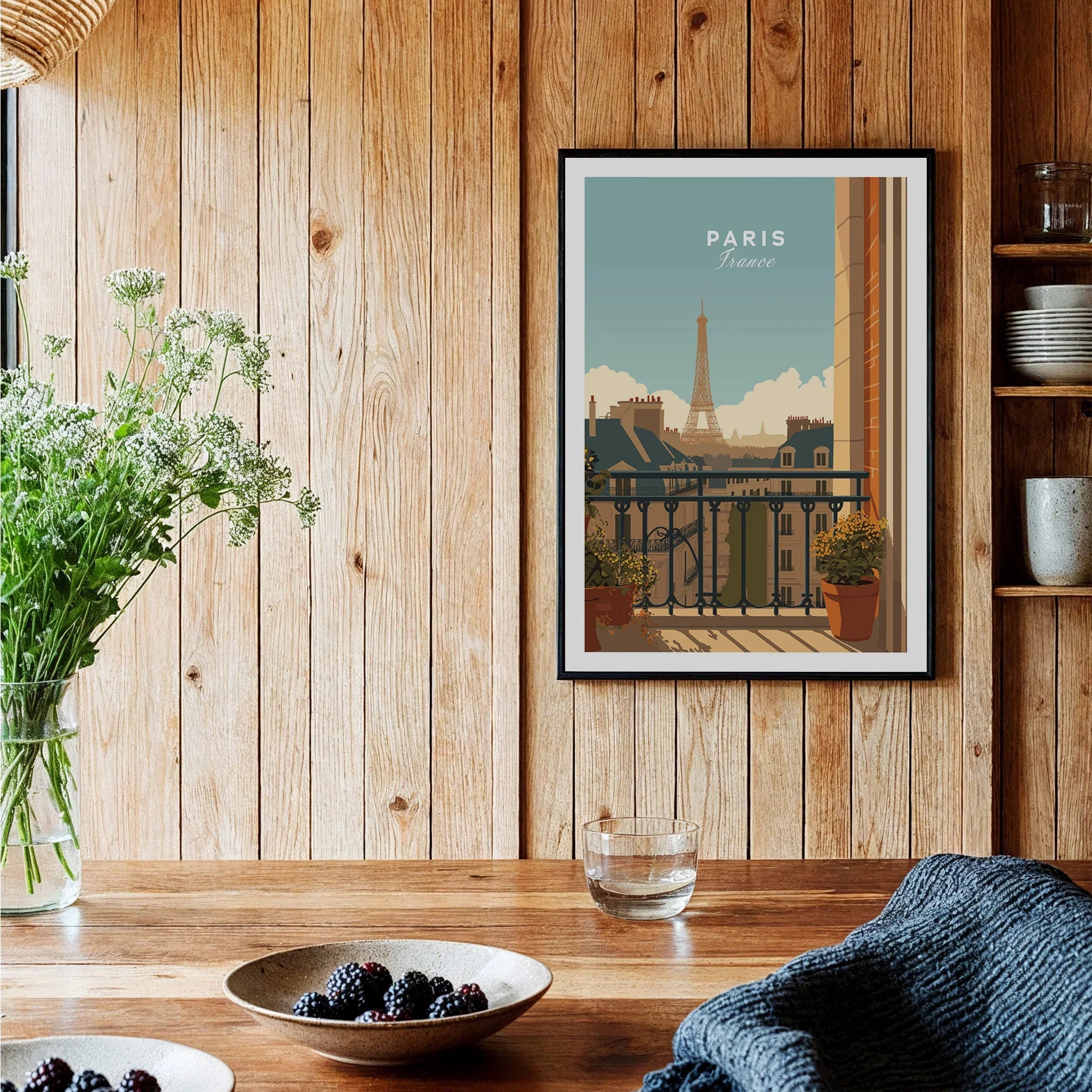 Paris travel poster art print in black frame displayed in rustic wood kitchen setting