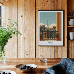 Paris travel poster art print in black frame displayed on wooden kitchen wall