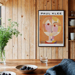 Paul Klee Senecio Head of Man Abstract Portrait Poster Art Print displayed in a cozy interior with wooden walls.
