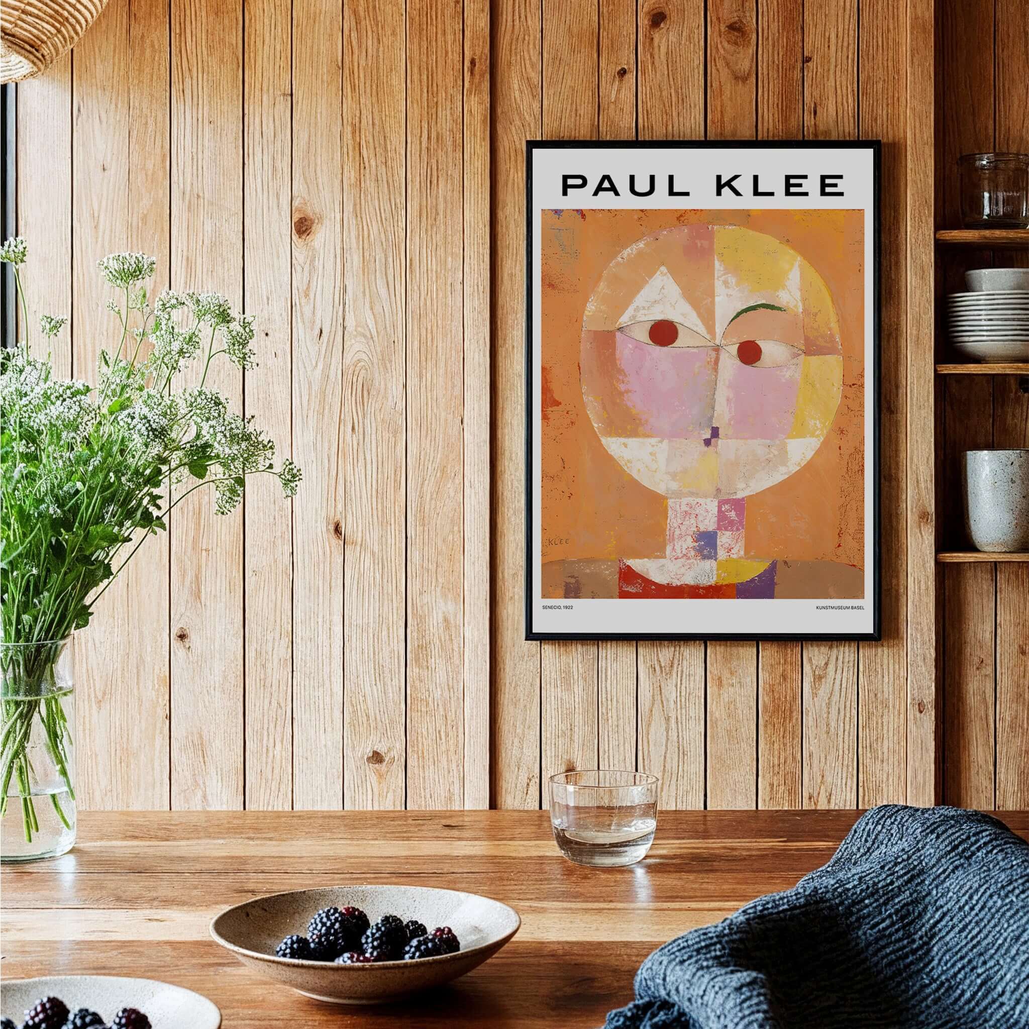 Paul Klee Senecio Head of Man Abstract Portrait Poster Art Print displayed in a cozy interior with wooden walls.