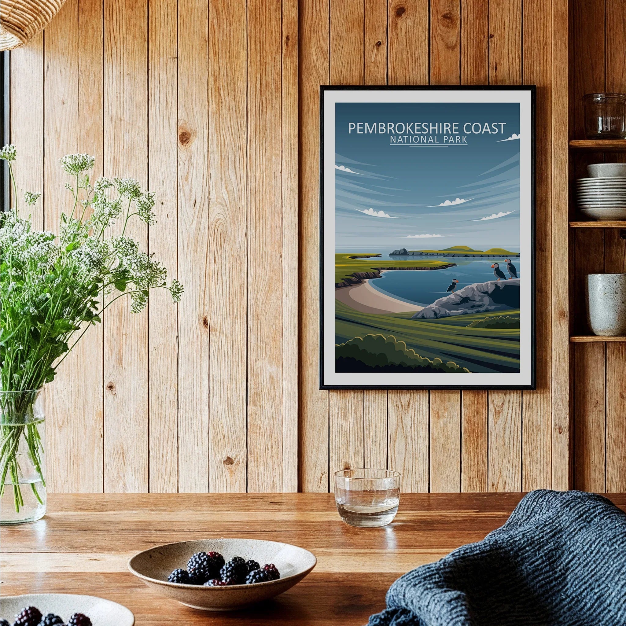 Pembrokeshire Coast National Park travel poster in black frame on rustic kitchen wall