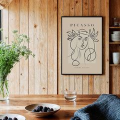 Picasso Line Art Woman Leaf Crown Modern Gallery Wall Art Poster displayed in a stylish interior with wood accents.