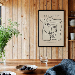 Picasso Abstract Face Hat Line Art Minimalist Portrait Poster Print Modern Gallery displayed in a cozy wooden interior.