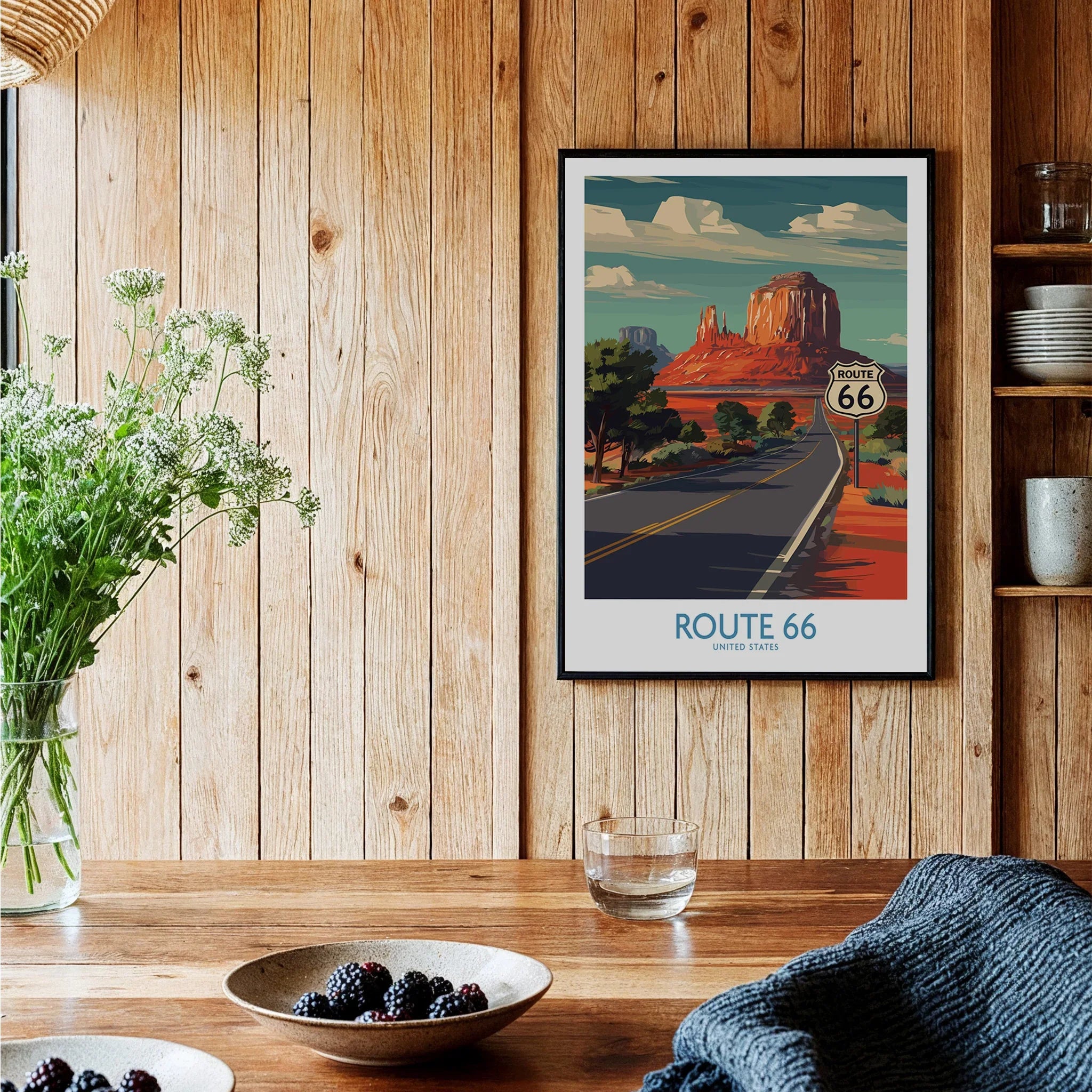 Route 66 travel poster framed wall art in rustic kitchen with wooden walls and table
