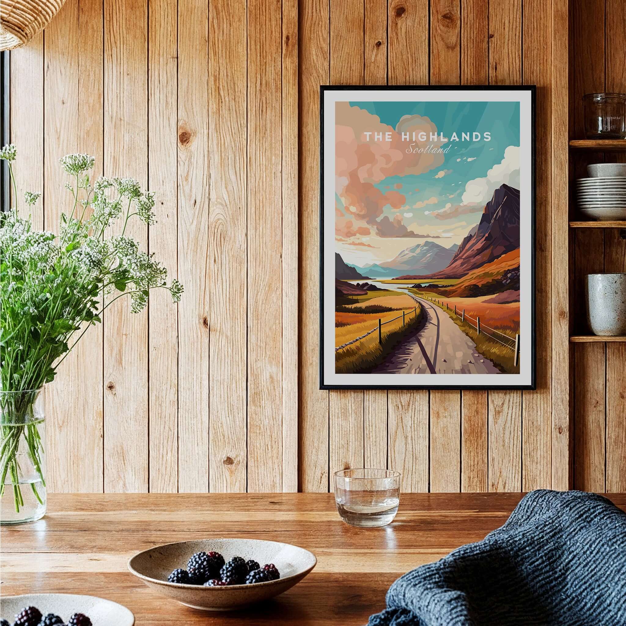 Scottish Highlands Art Print displayed in a rustic wooden setting with a vase of flowers and a bowl of berries.
