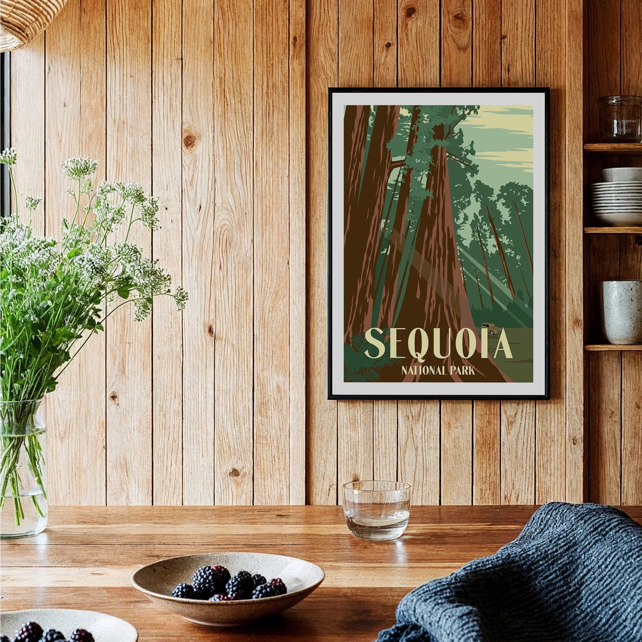 Sequoia National Park art print with tall trees in black frame on wooden kitchen wall