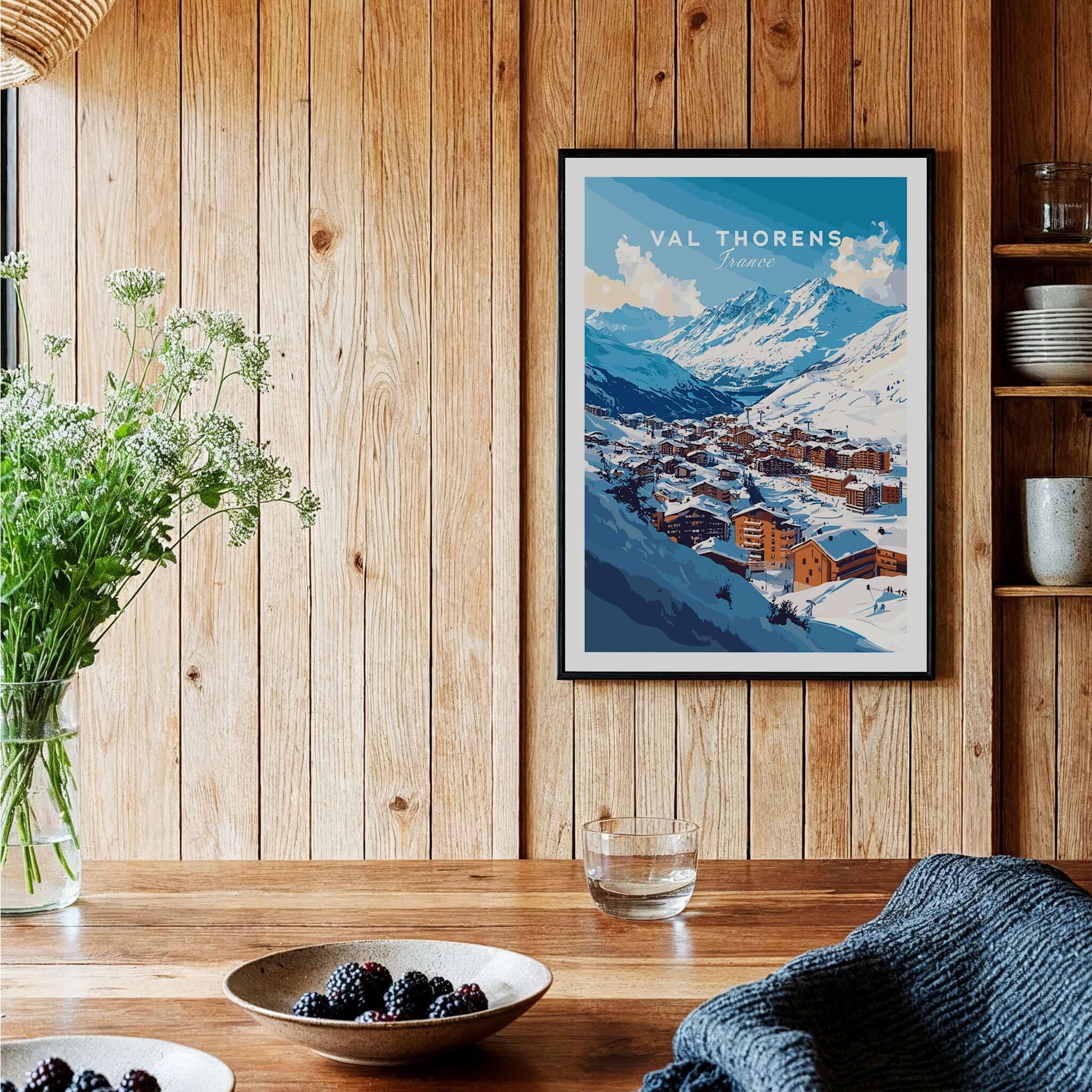French Alps Ski Village Poster | Cosy Val Thorens Scene displayed in a cozy wooden interior with flowers.