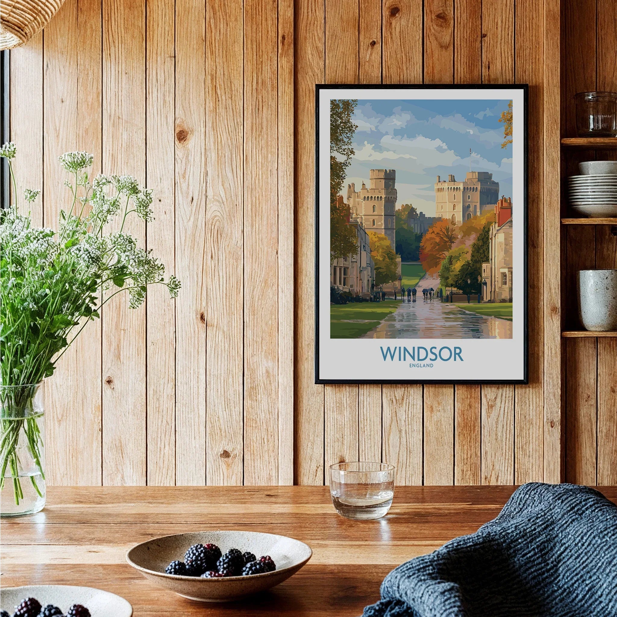 Windsor travel poster framed on wooden kitchen wall with plants and berries on table