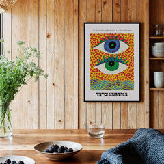 Yayoi Kusama Colorful Eyes Abstract Pattern Contemporary Art Print Paris Poster displayed on a wooden wall with plants.