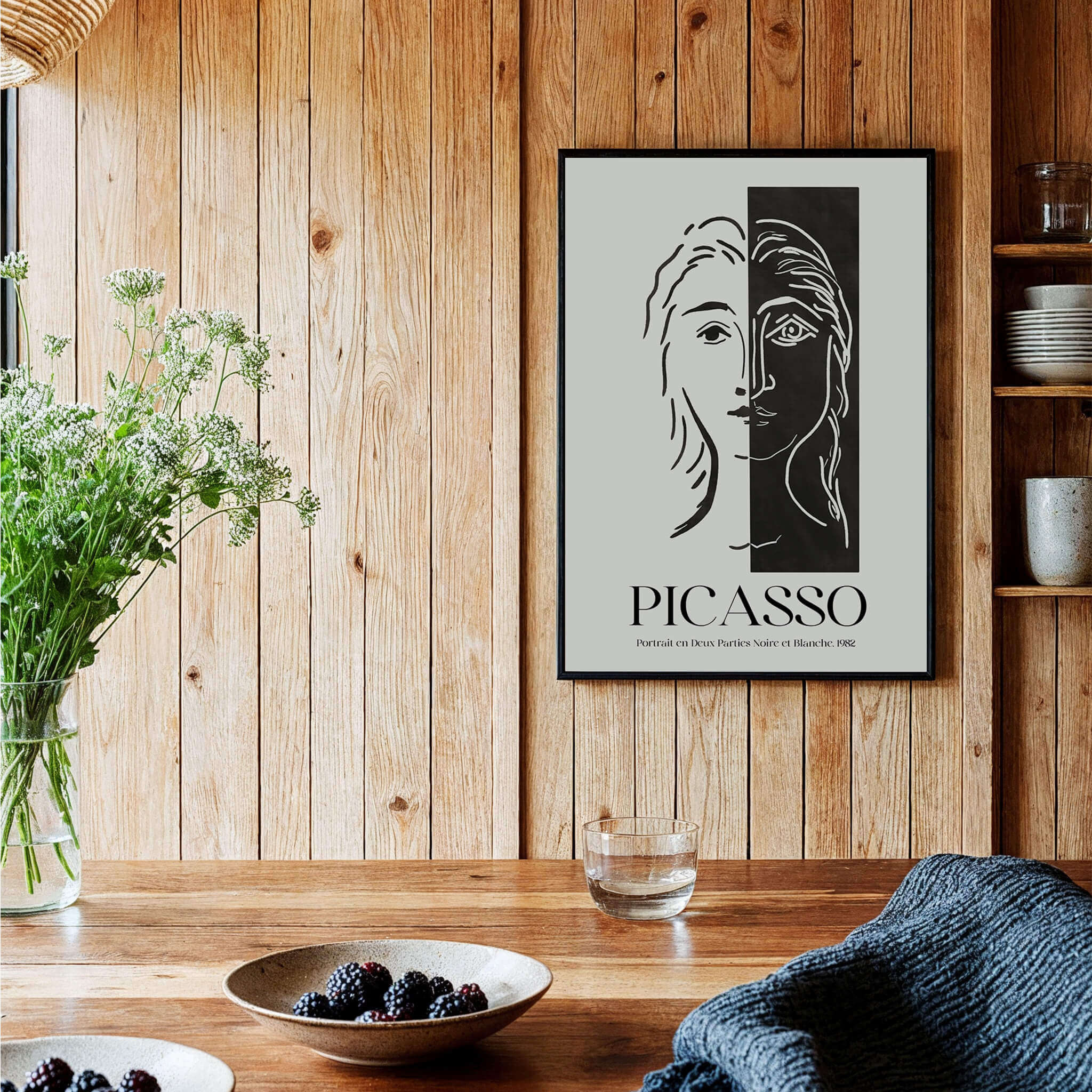 Picasso Portrait Deux Parties Black White Split Face Art Print Poster displayed on a wooden wall, showcasing abstract portrait design.