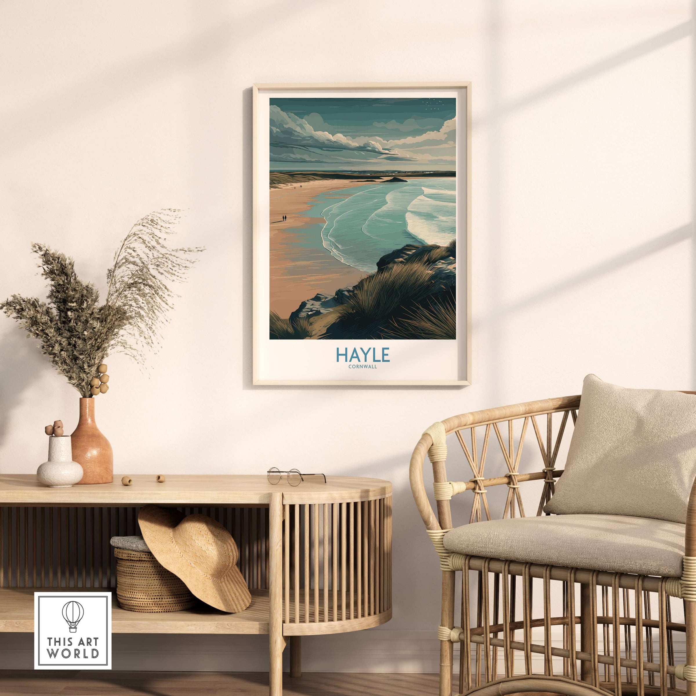 Hayle Sandy Beach Poster - Cornish Travel Decor displayed on a wall above a rattan chair in a cozy interior.