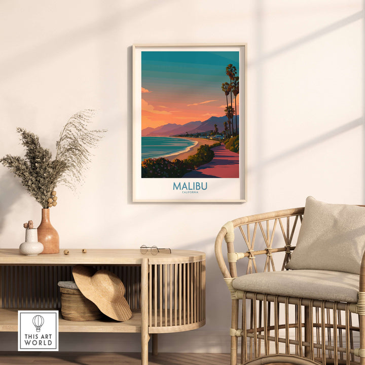 Malibu beach sunset poster displayed in a cozy living room with a rattan chair and decorative plants.