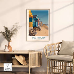 Southwold England Travel Poster featuring colorful beach huts along the coastline in a stylish interior setting.