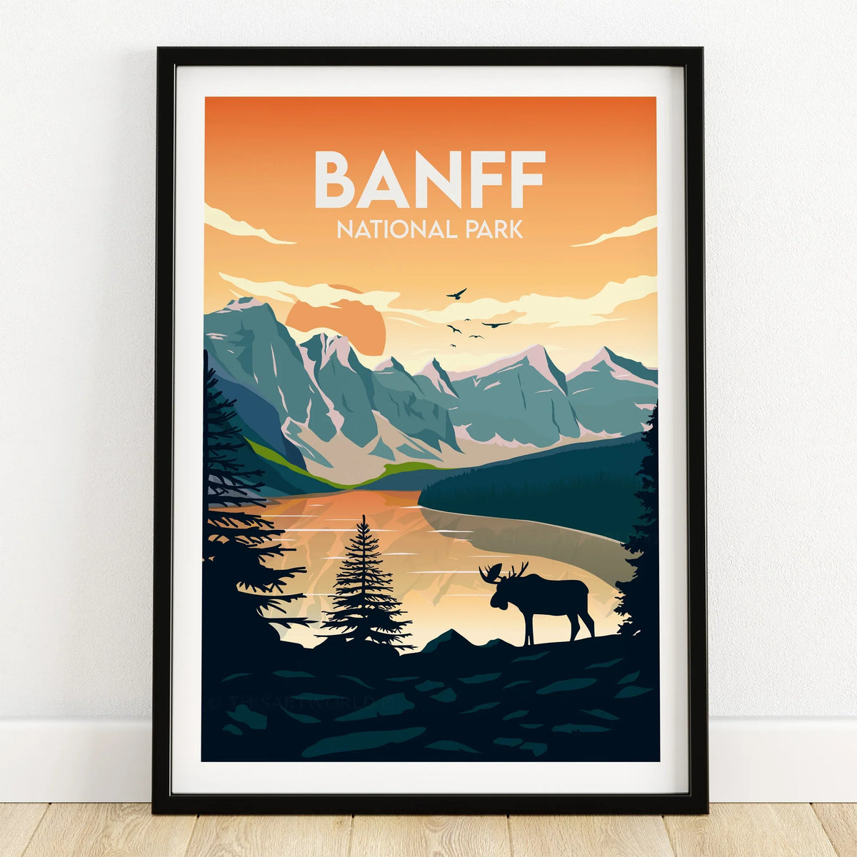 Banff National Park art print in black frame featuring mountains, lake, and moose silhouette