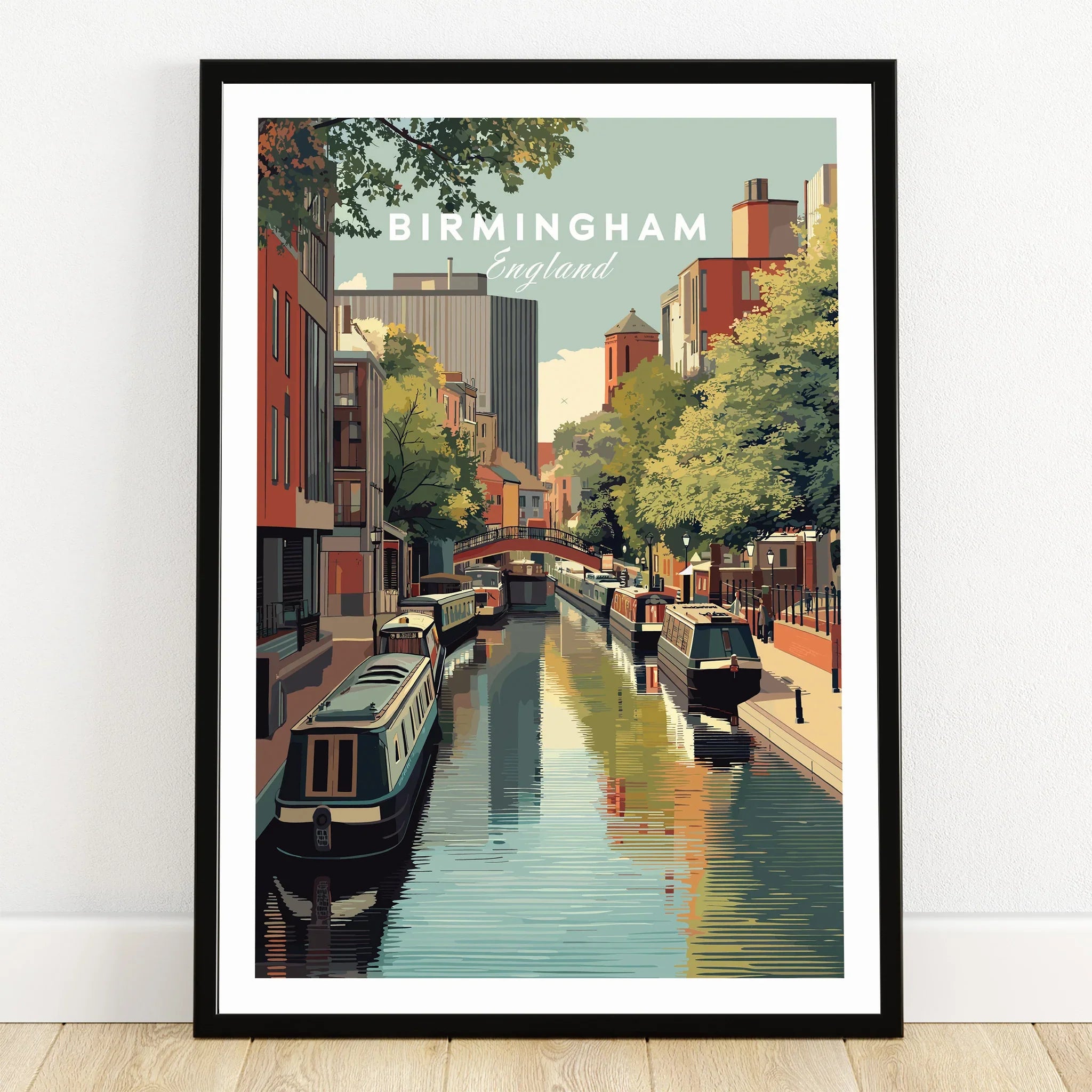 Birmingham England canal art print in black frame on wooden floor, skyline and boats