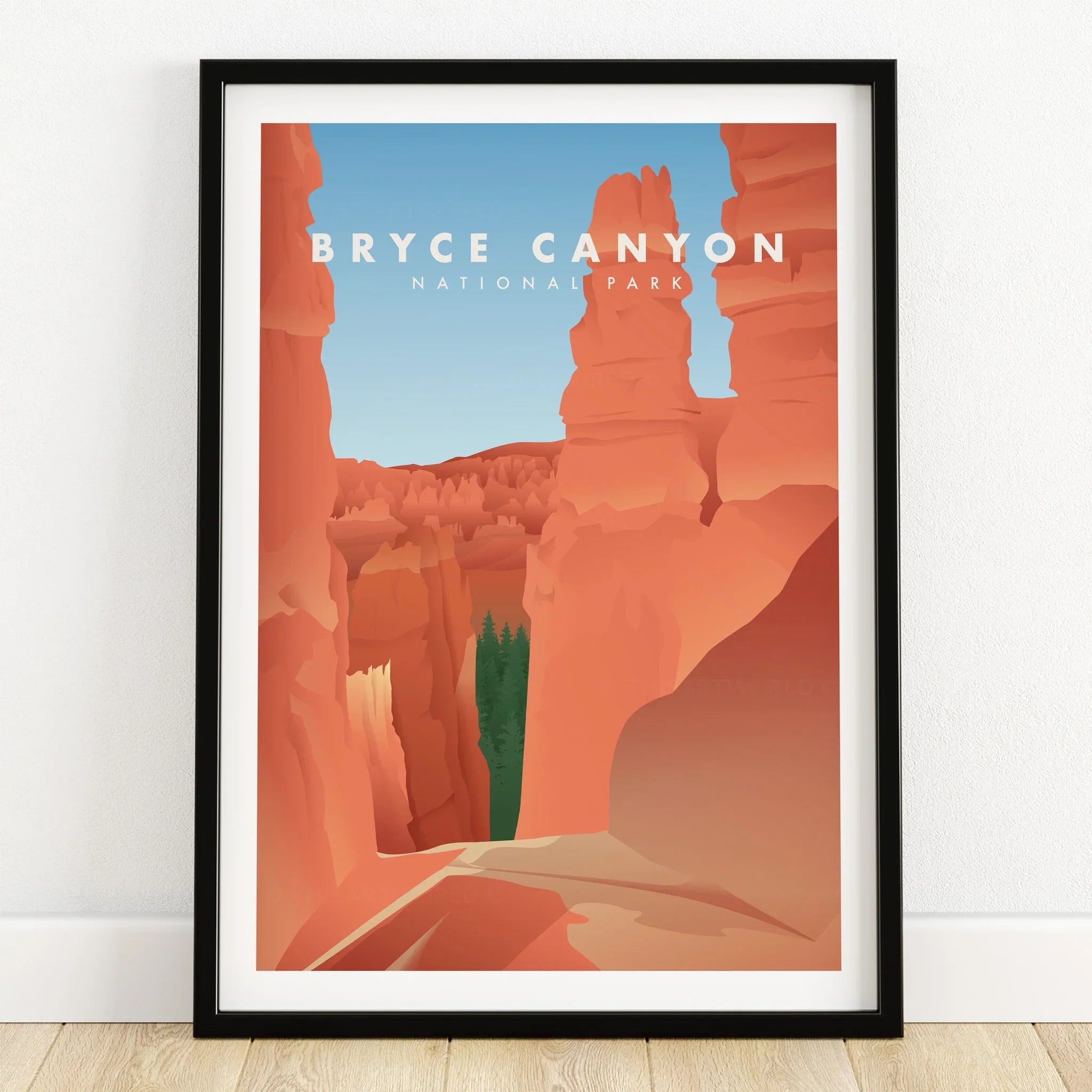 Bryce Canyon National Park art print in black frame on wooden floor, red rock landscape.