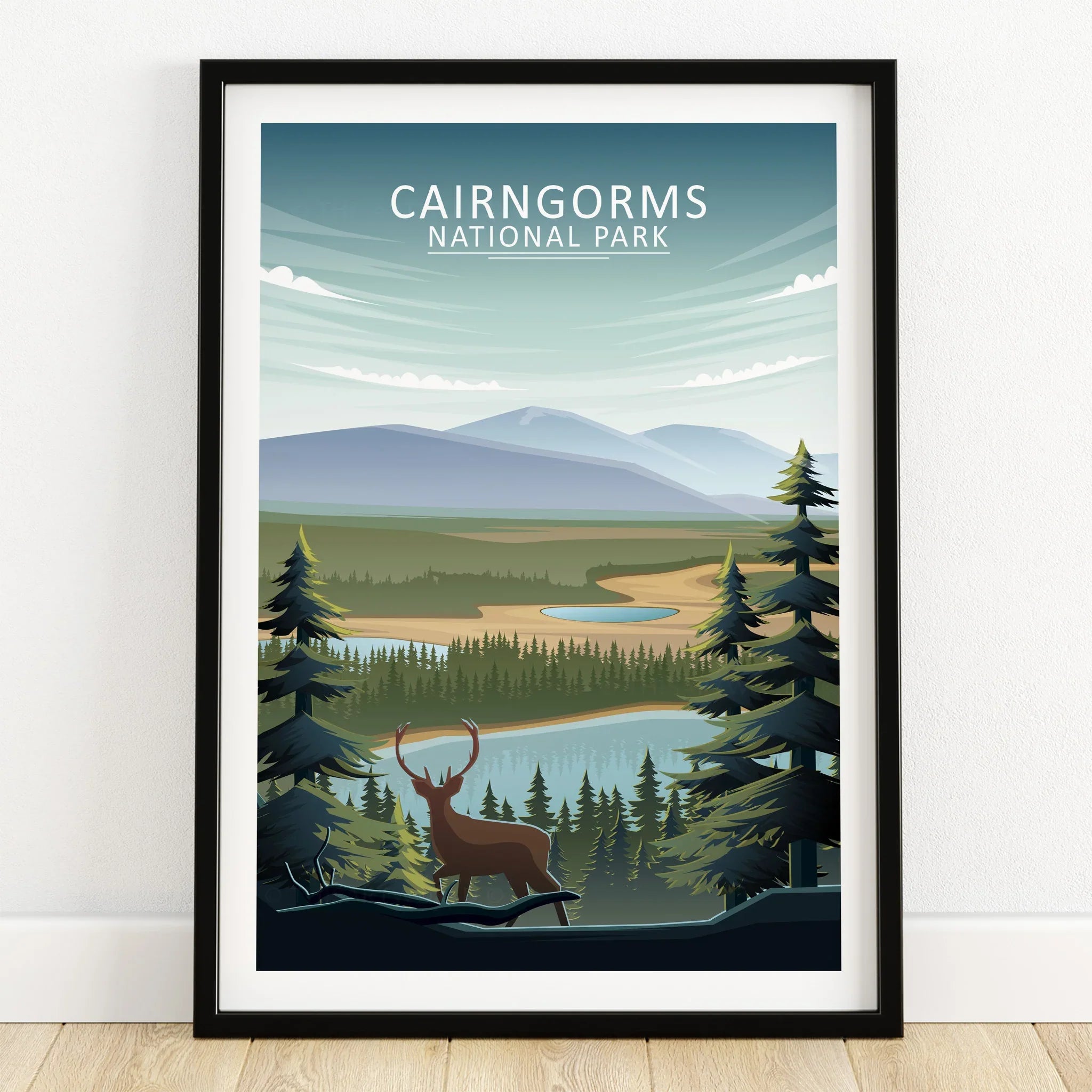 Cairngorms National Park art print with stag, pine trees, lake, and mountain landscape in black frame.