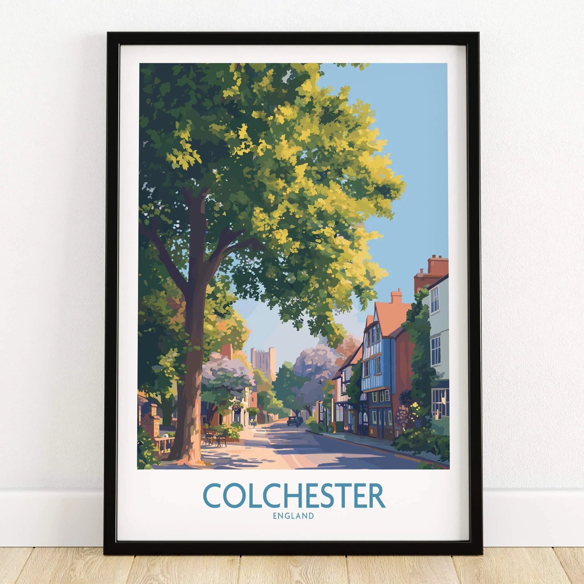 Colchester England art print in black frame, showing a scenic street with trees and historic buildings