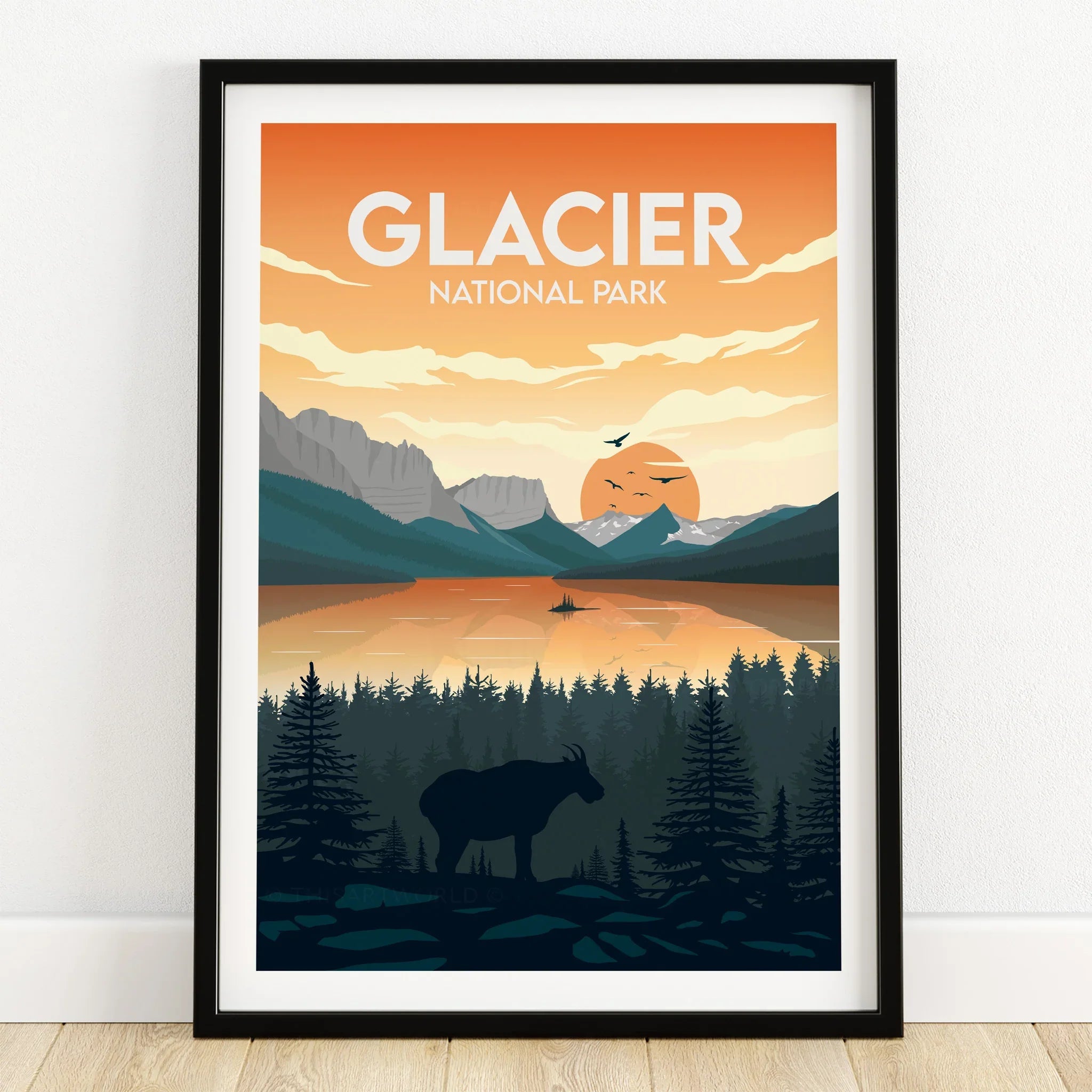 Glacier National Park art print in black frame, sunset over mountains, lake, and wildlife silhouette