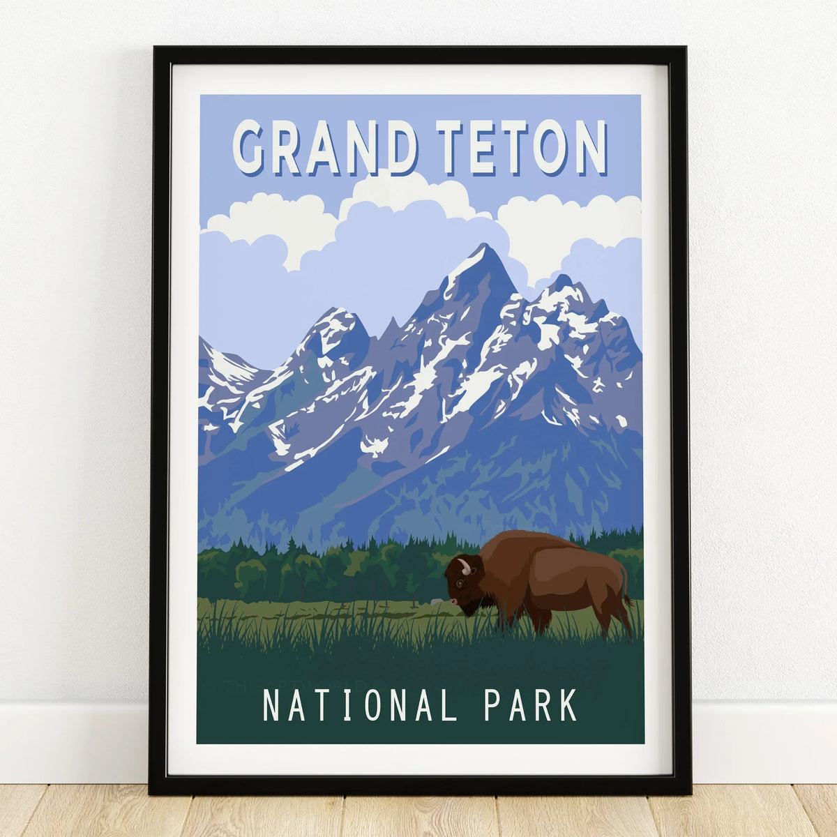 Grand Teton National Park art print with mountains and bison in black frame on wooden floor