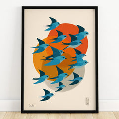 Modern art print of blue birds flying with orange and yellow abstract shapes in black frame