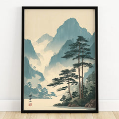 Framed Japanese woodblock art print with misty blue mountains and pine trees, on wooden floor
