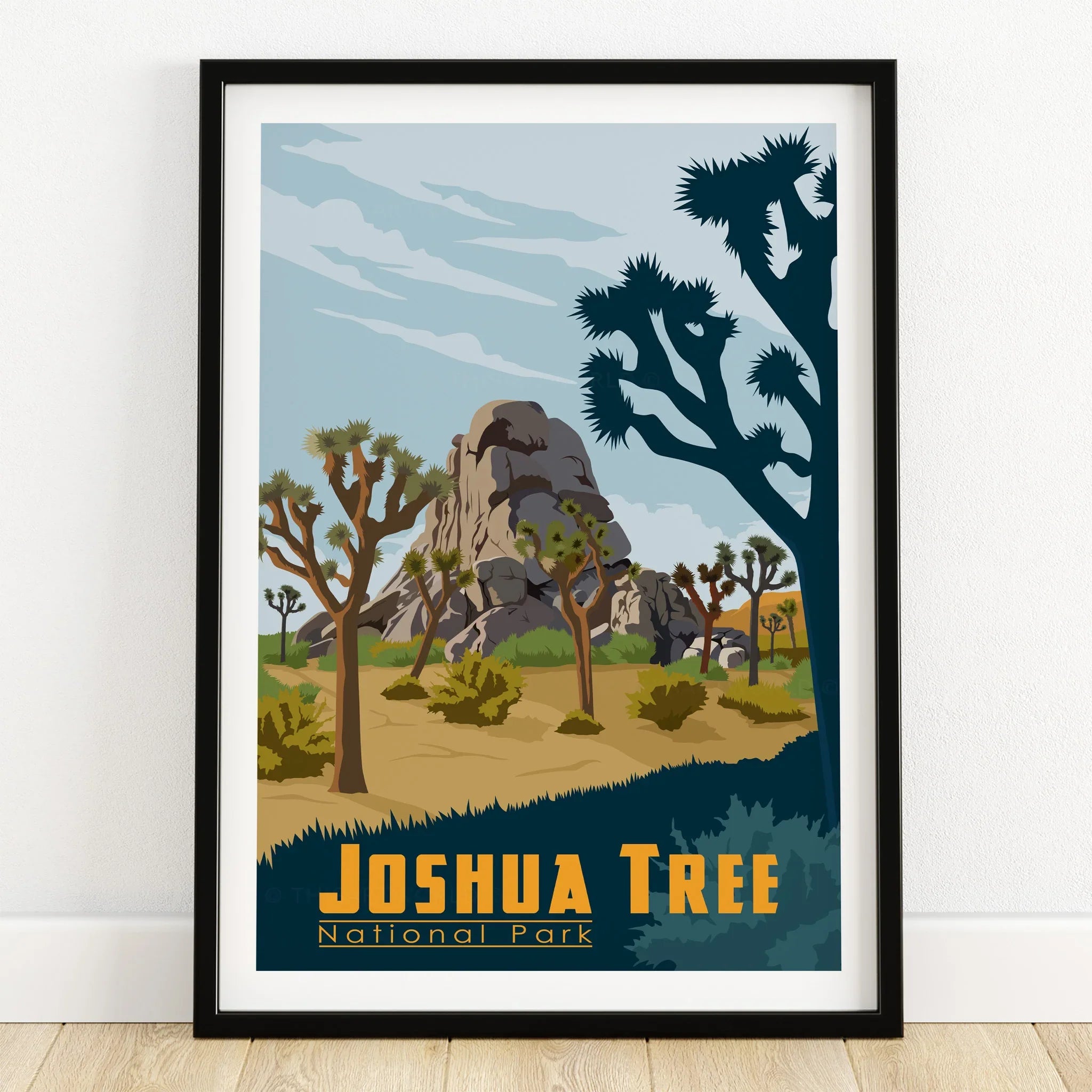 Joshua Tree National Park art print with desert landscape in black frame on wooden floor