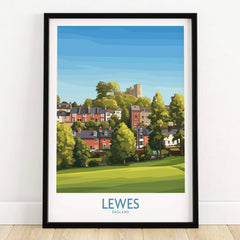 Lewes England art print in black frame, featuring colorful houses, greenery, and a castle.