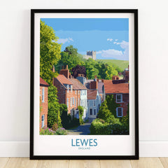 Lewes travel poster art print in black frame featuring colorful houses and castle on a wooden floor