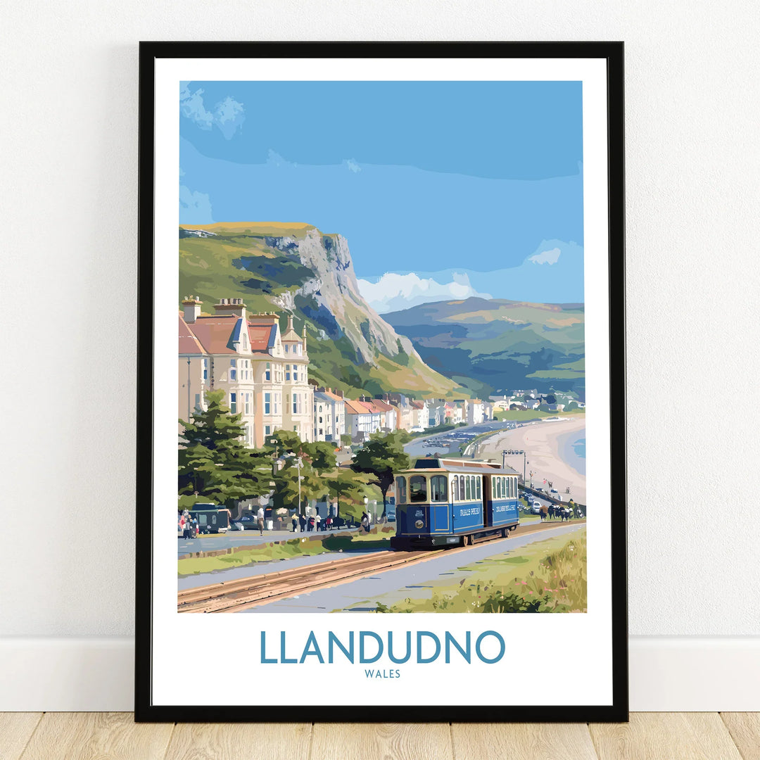 Llandudno Wales art print with seaside tram, Victorian buildings, coastal cliffs and beach in black frame