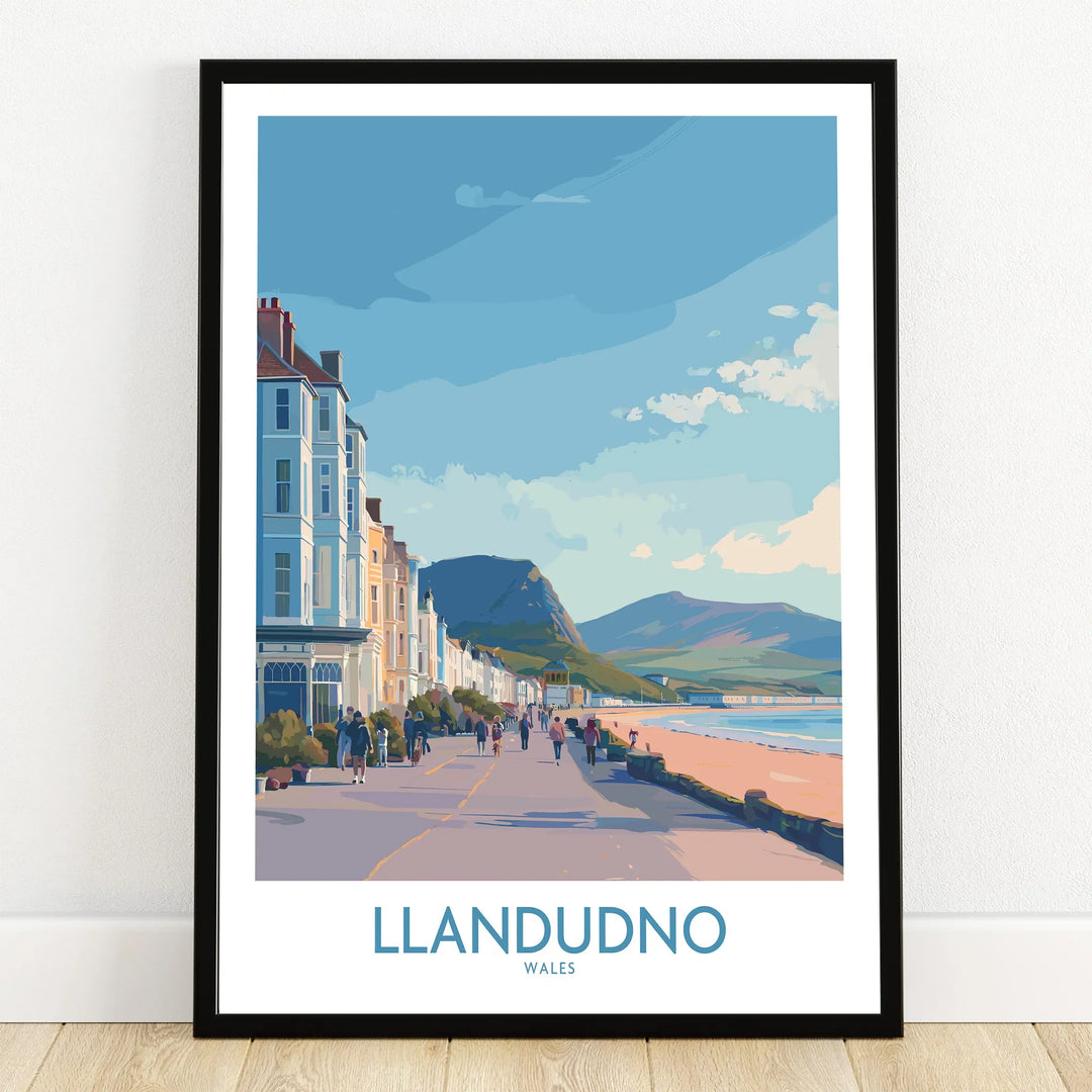 Llandudno Wales travel poster art print in black frame on wooden floor, seaside promenade scene.