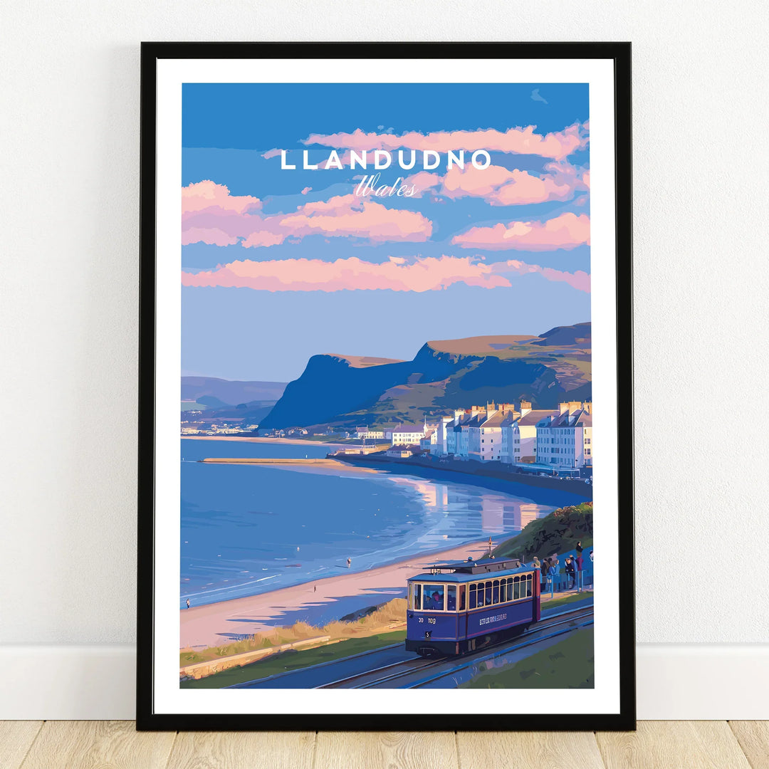 Llandudno Wales travel poster art print in black frame with beach, tram, and coastal town scene