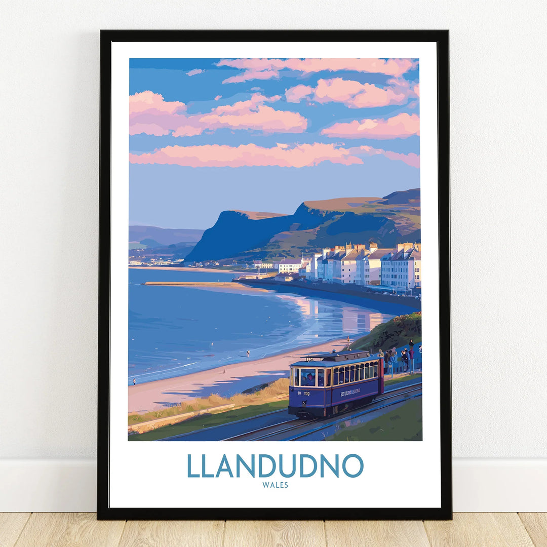 Llandudno Wales travel poster print in black frame, featuring seaside tram, beach and cliffs.