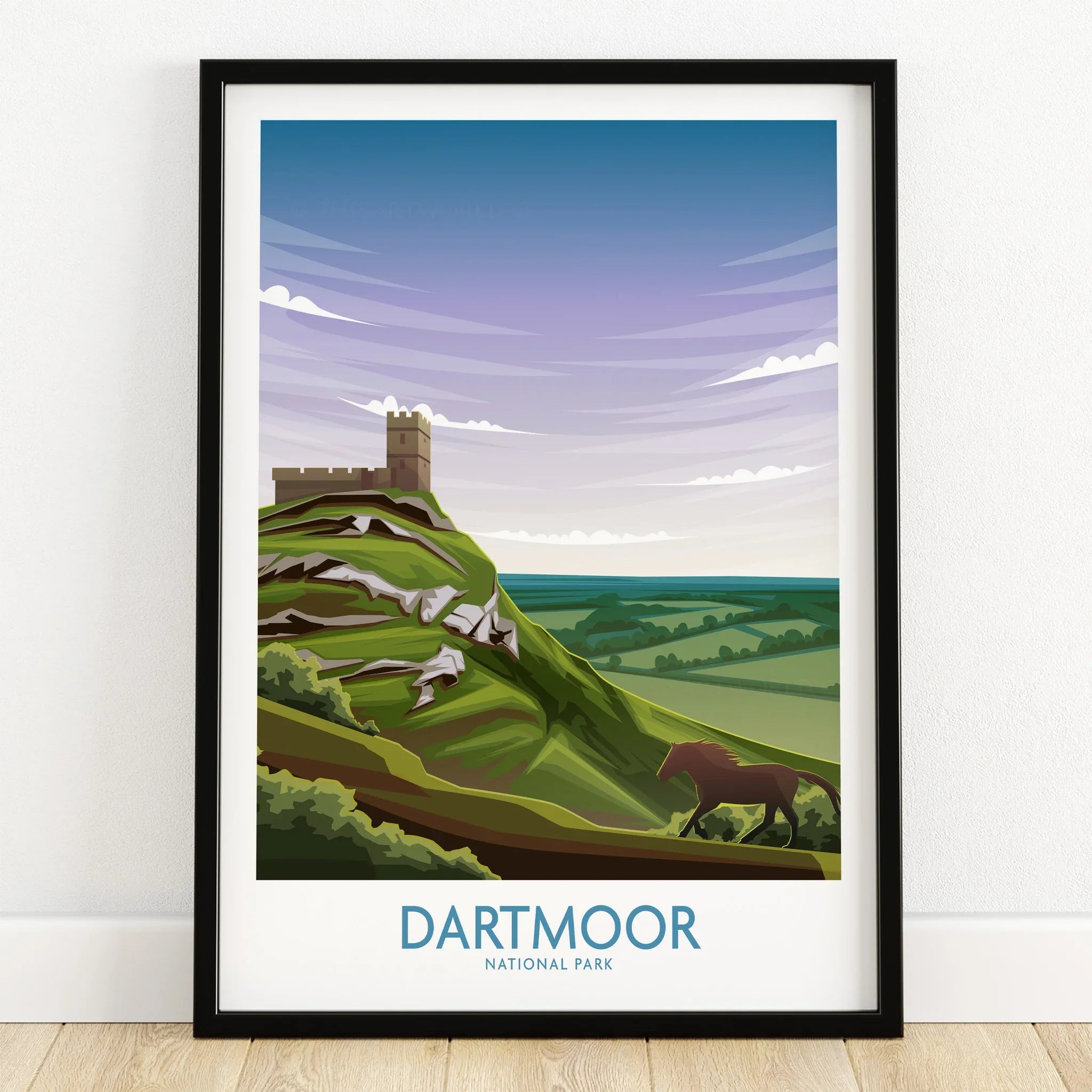 Dartmoor National Park art print in black frame, showing castle on green hill with horse, landscape wall art