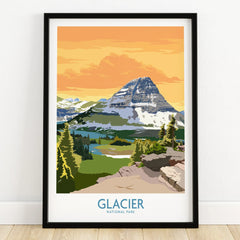 Glacier National Park art print in black frame, mountain landscape with orange sky, on wooden floor