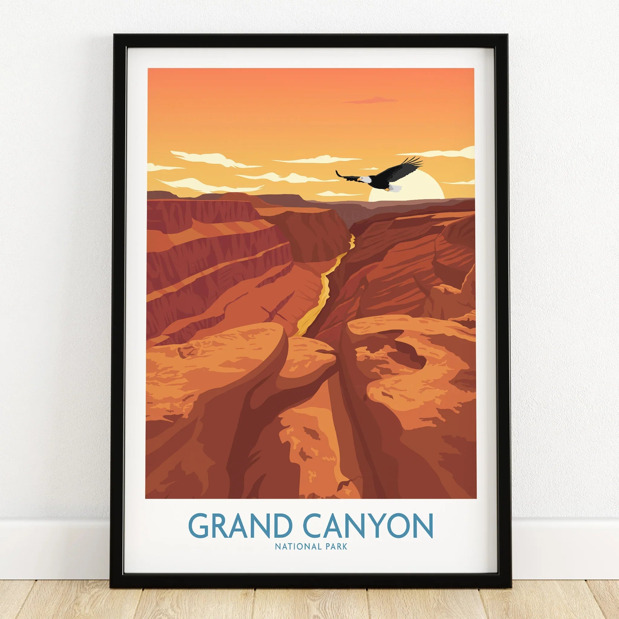Grand Canyon National Park art print in black frame on wooden floor, sunset landscape with canyon and eagle.