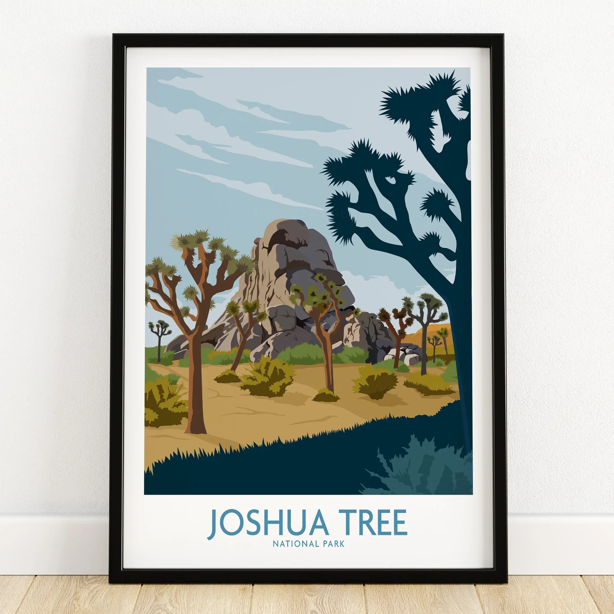 Joshua Tree National Park art print in black frame on wooden floor, desert landscape illustration