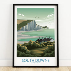 South Downs National Park art print in black frame, coastal cliffs and cottages illustration