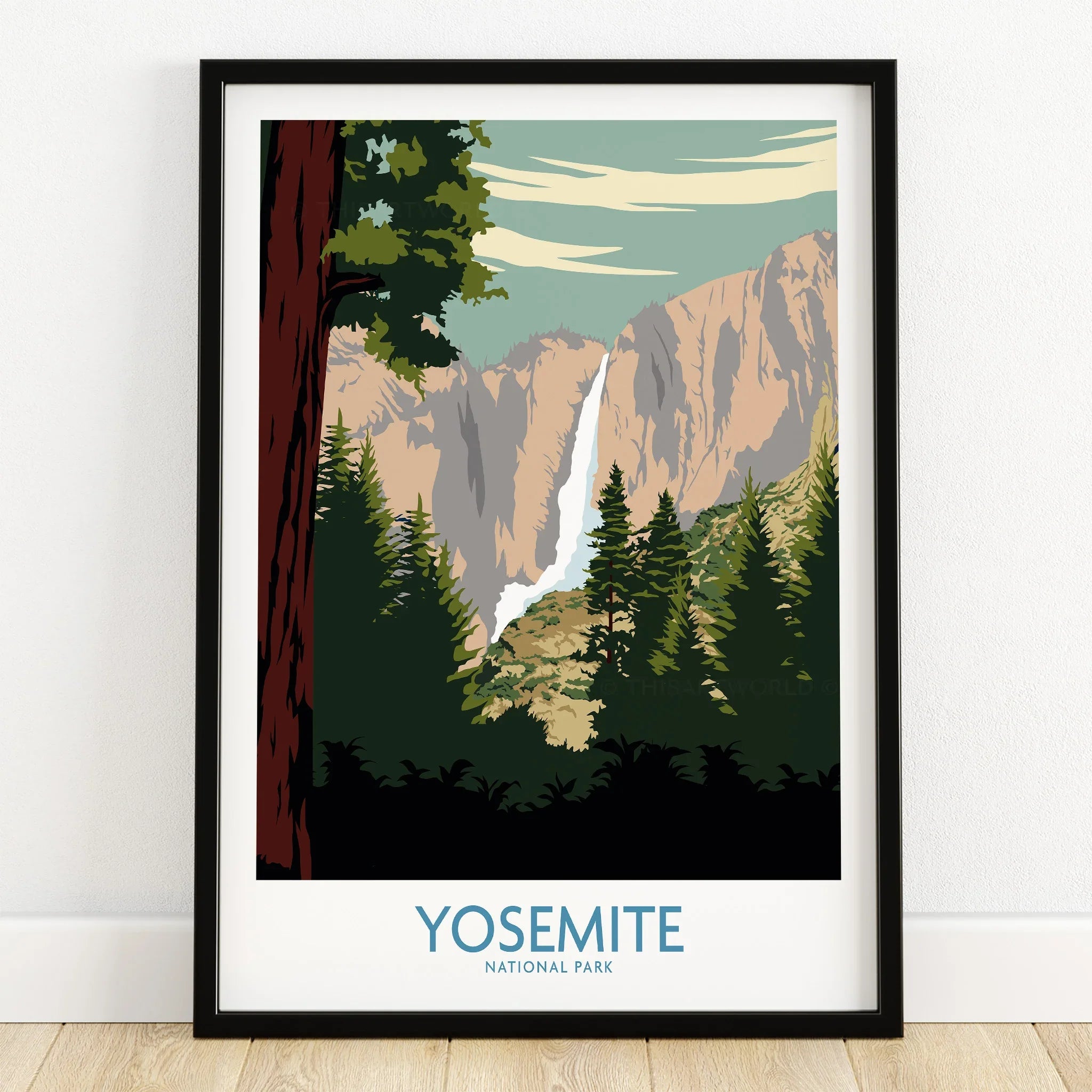 Yosemite National Park art print in black frame, featuring waterfall and pine trees, on wooden floor.